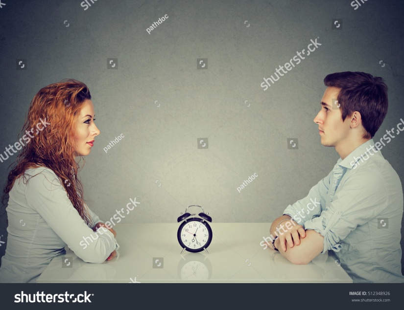 stock-photo-speed-dating-man-and-woman-sitting-across-from-each-other-at-table-with-alarm-clock-in-between-512348926 (1)